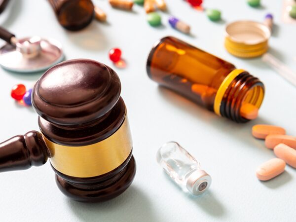 Gavel with pills and pill bottles